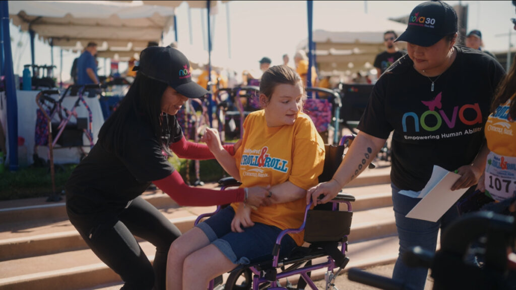 A woman in a wheelchair is being helped by another person during the Stroll and Roll event in November.