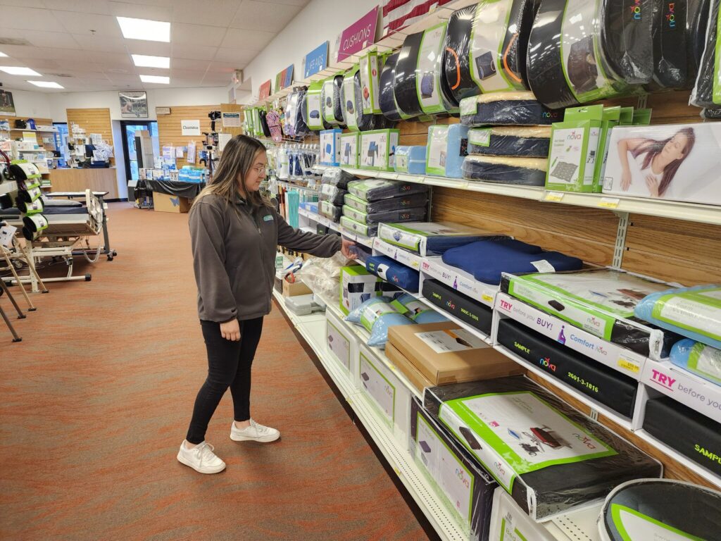 A woman looking at the shelves of a NOVA Home Medical Equipment MVP store.