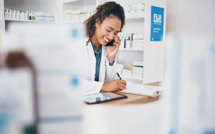 female pharmacist on the phone with supplier of wholesale medical supplies