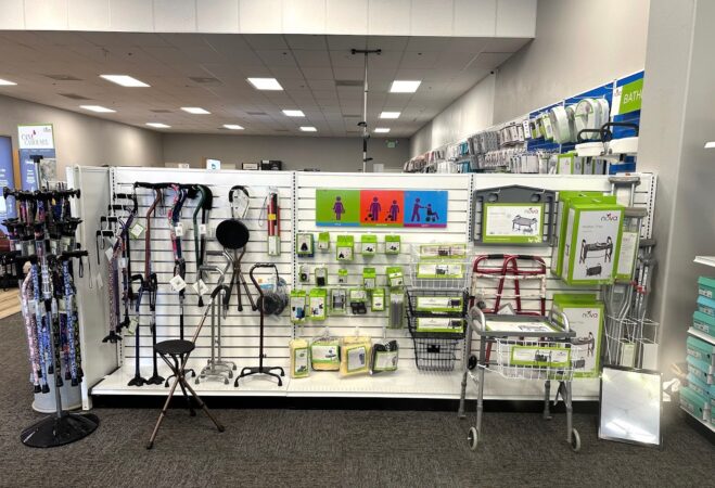 A retail display of colorful NOVA canes, walkers, rollators, and accessories; types of mobility aids displayed for sale in a pharmacy medical supply store
